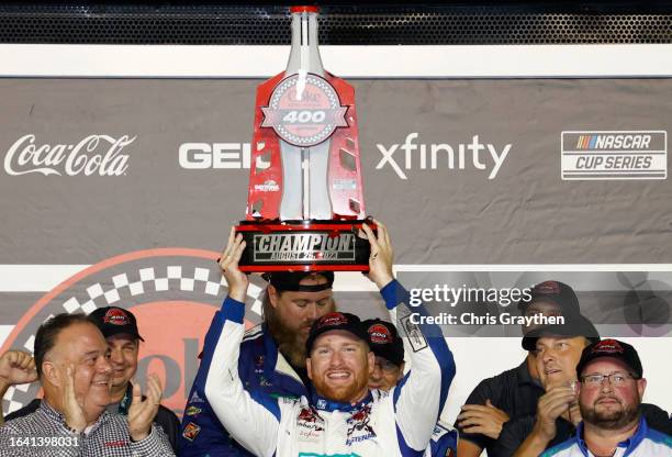 Chris Buescher, driver of the Fifth Third Bank Ford, celebrates in victory lane after winning the NASCAR Cup Series Coke Zero Sugar 400 at Daytona...