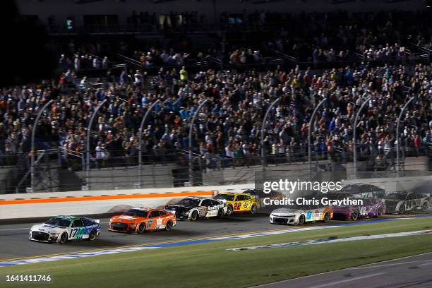 Chris Buescher, driver of the Fifth Third Bank Ford, leads the field to the finish line to win the NASCAR Cup Series Coke Zero Sugar 400 at Daytona...