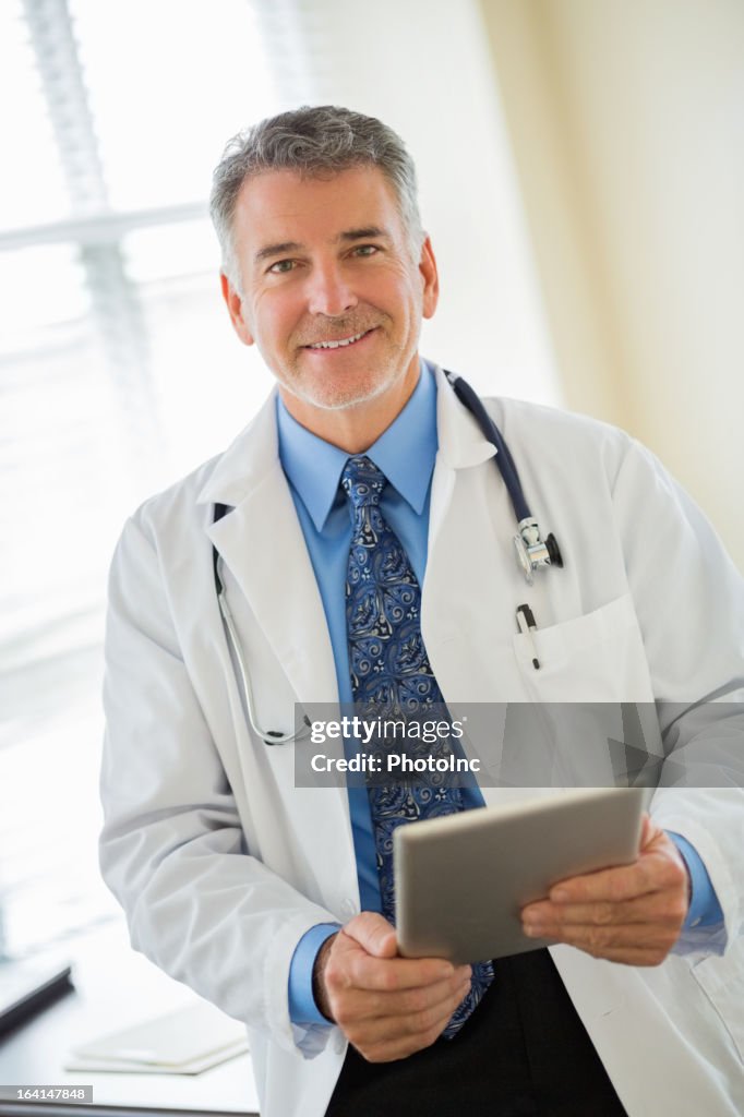 Male Doctor Holding Tablet Computer