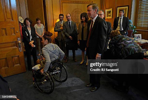 Karina Vargas, who was paralyzed from a shooting outside Aurora Central High School, leaves Colorado Governor John Hickenlooper's office after he...