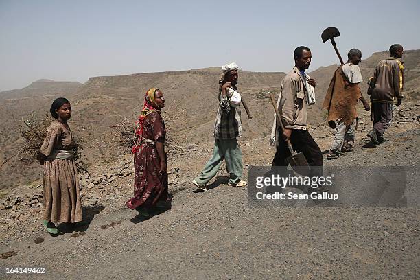 People walk by the side of the road in the Lasta mountain range on March 19, 2013 near Lalibela, Ethiopia. Ethiopia, with an estimated 91 million...