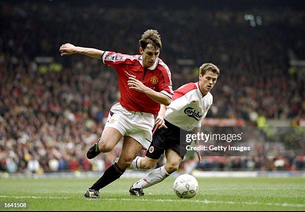 Gary Neville of Manchester United gets the better of Michael Owen of Liverpool in the FA Cup fourth round clash at Old Trafford in Manchester,...