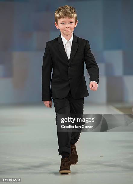 Model wearing Paul Smith Junior Spring/Summer '13 walks the runway at the Global Kids Fashion Week SS13 public show in aid of Kids Company at The...