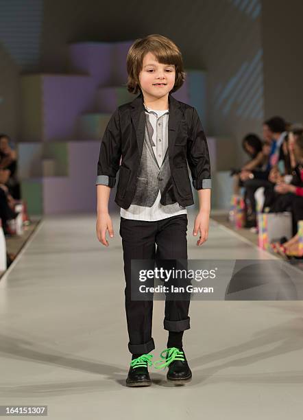 Model wearing Sierra Julian Spring/Summer '13 walks the runway at the Global Kids Fashion Week SS13 public show in aid of Kids Company at The...