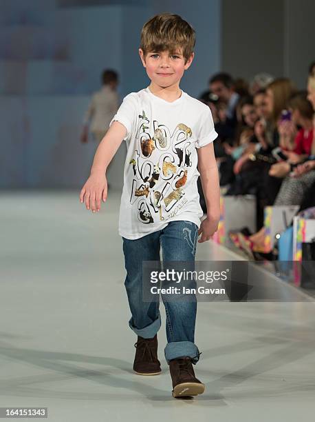 Model wearing Roberto Cavalli Spring/Summer '13 walks the runway at the Global Kids Fashion Week SS13 public show in aid of Kids Company at The...