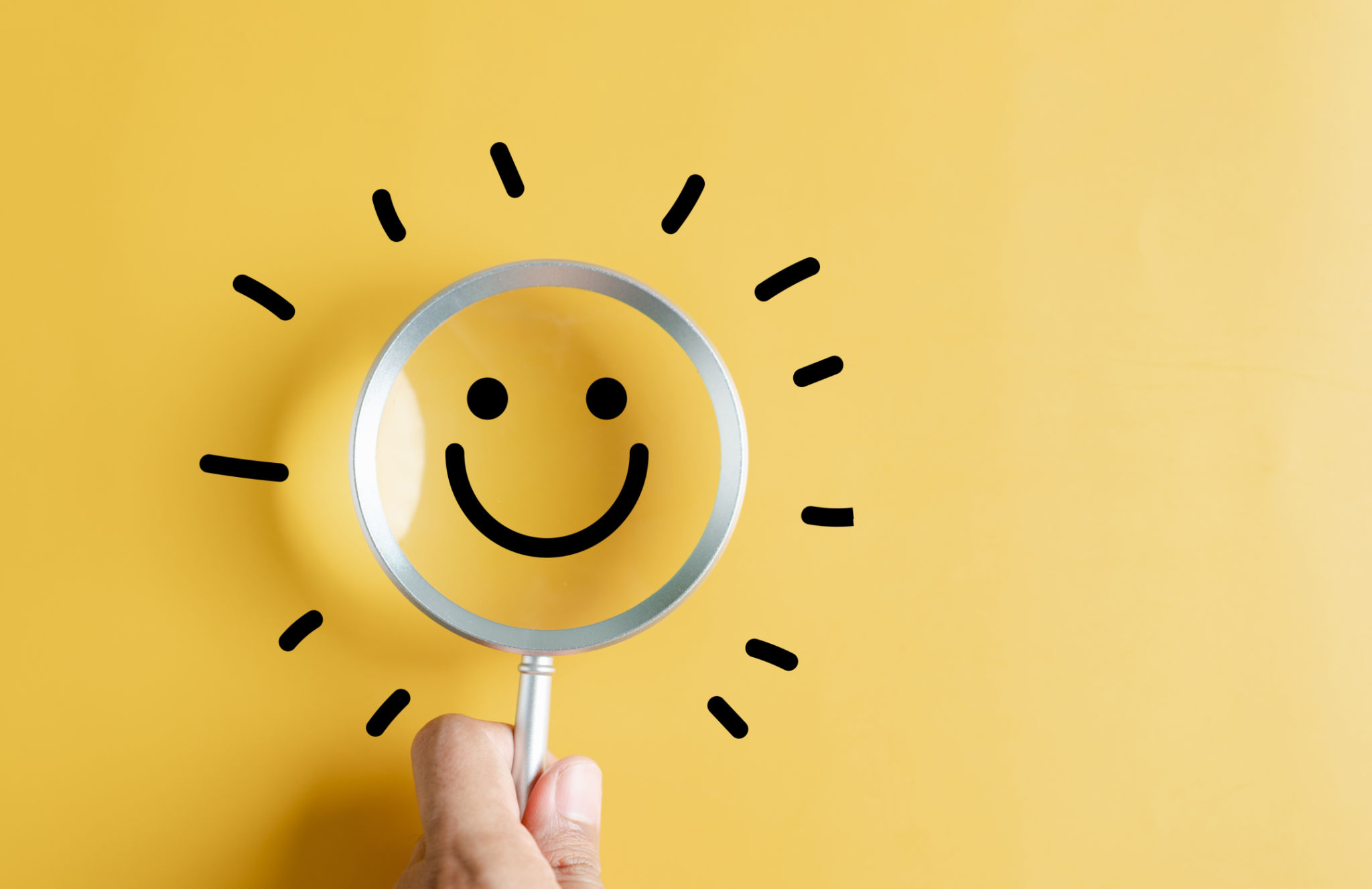 Magnifier focus to smile face emoticon with light bulb smart idea, creativity and solution concept. Magnifier focus to smile face emoticon with light bulb smart idea, creativity and solution concept.