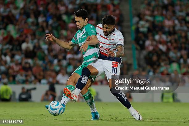 Ismael Govea of Santos fights for the ball with Ernesto Vega of Chivas during the 6th round match between Santos Laguna and Chivas as part of Torneo...