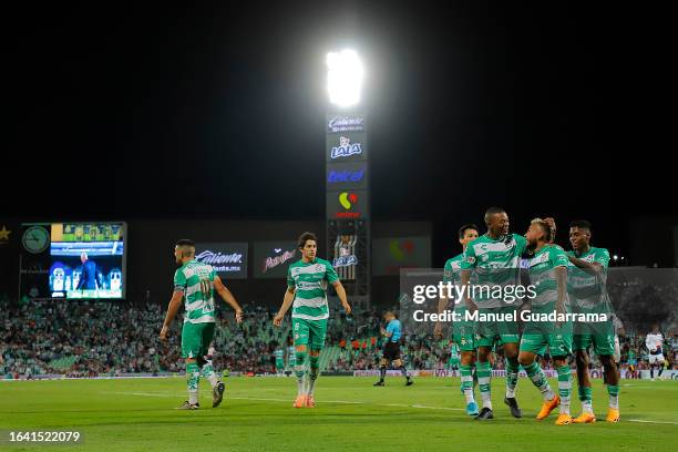 Duvan Vergara of Santos celebrates with teammates after scoring the team's second goal during the 6th round match between Santos Laguna and Chivas as...