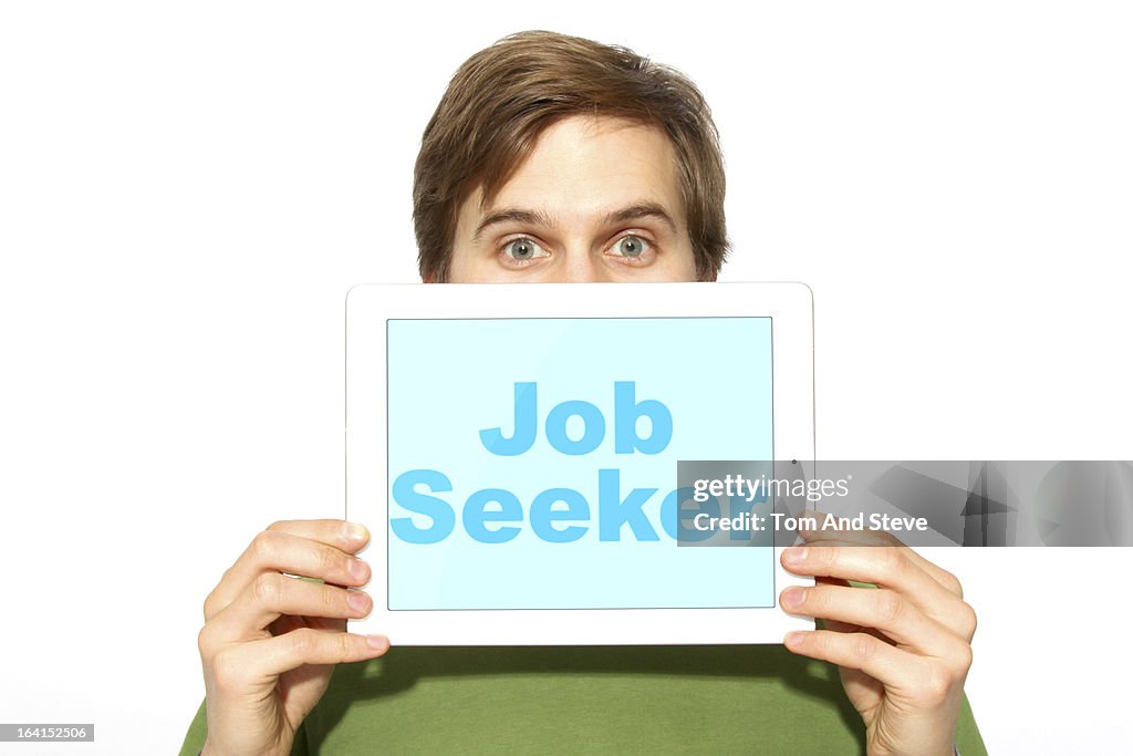 Job seeker holding sign on tablet computer