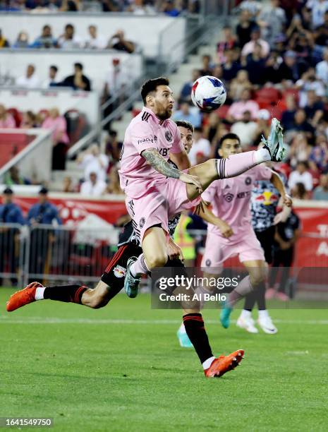 Lionel Messi of Inter Miami CF jumps for the ball in the second half during a match between Inter Miami CF and New York Red Bulls at Red Bull Arena...