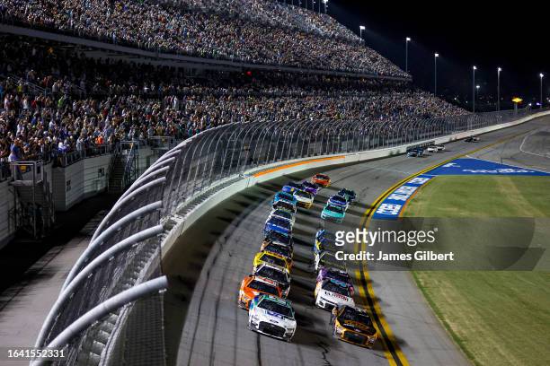 Chris Buescher, driver of the Fifth Third Bank Ford, and Kevin Harvick, driver of the GEARWRENCH Ford, lead the field during the NASCAR Cup Series...