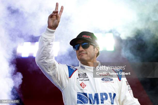 Yeley, driver of the Biohaven/Jacob Co. Ford, waves to fans as he walks onstage during driver intros prior to the NASCAR Cup Series Coke Zero Sugar...