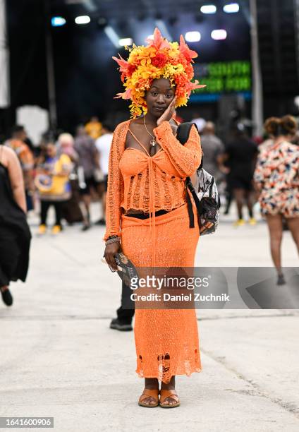 Kayla Dike is seen wearing an orange Fashion Nova outfit with a floral headpiece during the 2023 Afropunk festival at Greenpoint Terminal on August...