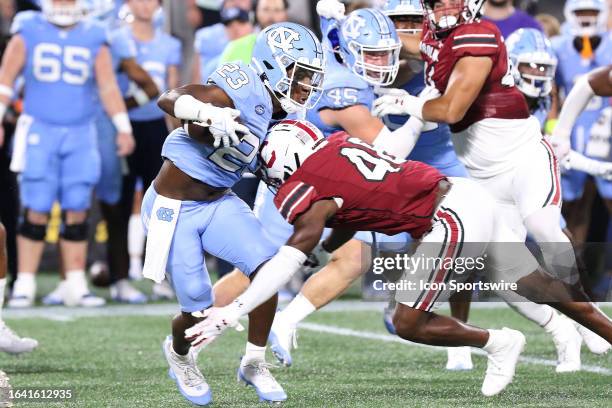 North Carolina Tar Heels running back George Pettaway is tackled by South Carolina Gamecocks edge Bryan Thomas Jr. During the Duke's Mayo Classic...