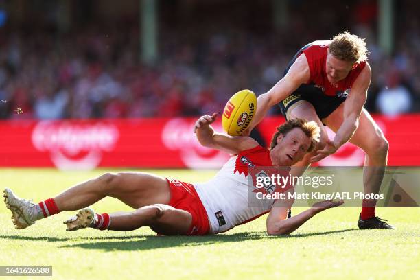 Callum Mills of the Swans is challenged by Clayton Oliver of the Demons during the round 24 AFL match between Sydney Swans and Melbourne Demons at...