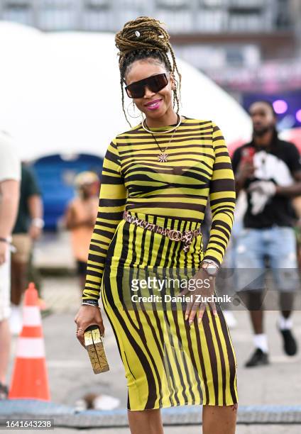 Patrice is seen wearing a yellow and black zebra print Fashion Nova top and skirt and black sunglasses during the 2023 Afropunk festival at...