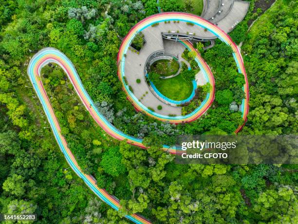 People walk along the city's Rainbow Walk into the green mountains in Fushan Country Park, Gulou District, Fuzhou, Fujian province, China, September...