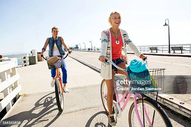 friends riding cruiser bikes. - boardwalk ストックフォトと画像