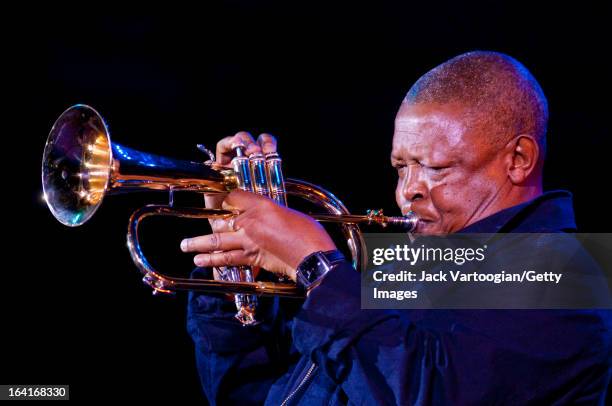 South African jazz musician Hugh Masekela plays fluegelhorn during the 'Keep A Light in The Window: An Homage To Joel Dorn' concert at Damrosch Park...