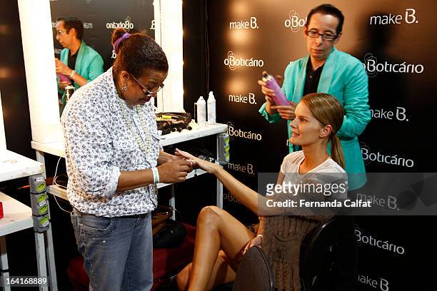 Model prepares backstage at the Agua de Coco show during Sao Paulo Fashion Week Summer 2013/2014 on March 20, 2013 in Sao Paulo, Brazil.