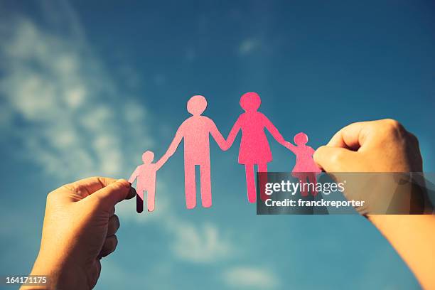 family paper dolls against the sky - human chain stockfoto's en -beelden