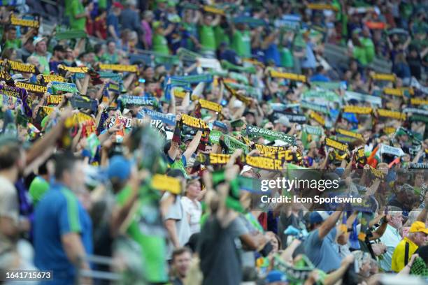 Fans show their support by raising their scares at the start of an MLS matchup between the Portland Timbers and the Seattle Sounders FC on September...