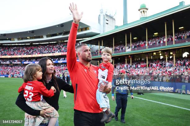 Lance Franklin of the Swans farewells the crowd with his wife Jesinta Franklin and children during a lap of honour during the round 24 AFL match...