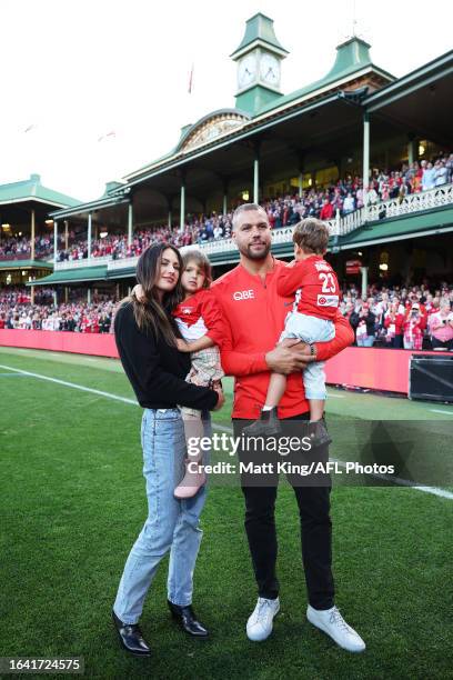 Lance Franklin of the Swans farewells the crowd with his wife Jesinta Franklin and children during a lap of honour during the round 24 AFL match...