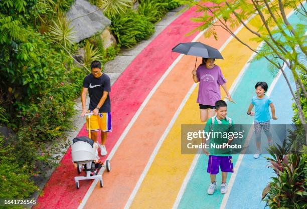 People walk along the city's Rainbow Walk into the green mountains in Fushan Country Park, Gulou District, Fuzhou, Fujian province, China, September...