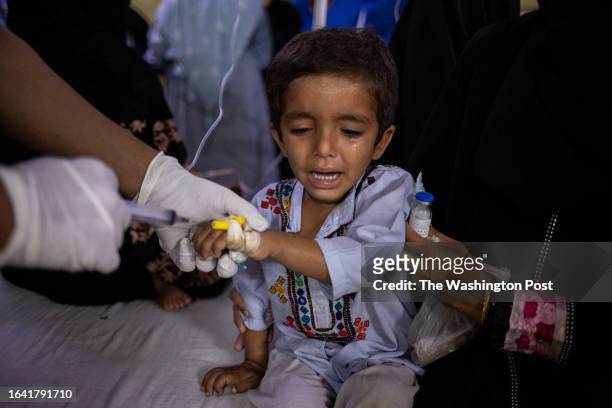 Sehwan, Sindh 6-year-old Rayan receives medicine through an IV while he suffers from diarrhoea at the designated heat stroke ward at the Sayed...