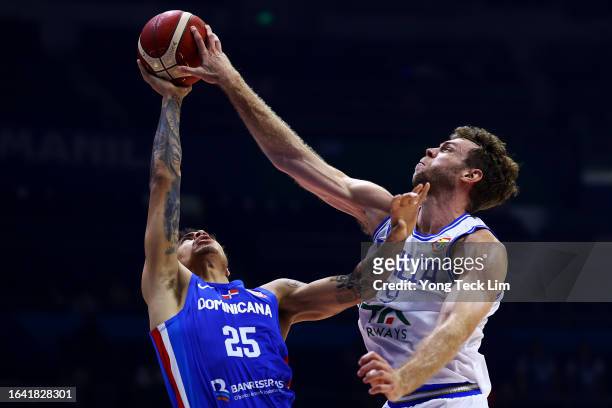 Lester Quinones of the Dominican Republic is blocked on a drive to the basket by Nicolo Melli of Italy in the first quarter during the FIBA...