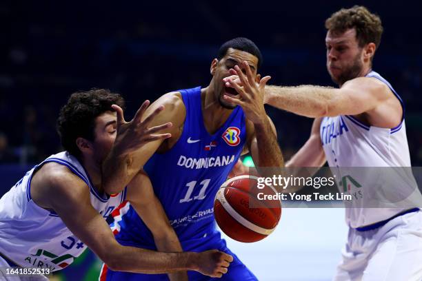 Eloy Vargas of the Dominican Republic loses control of the ball against Alessandro Pajola and Nicolo Melli of Italy in the first quarter during the...