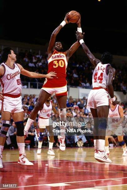 Tree Rollins of the Atlanta Hawks shoots a jumpshot during the 1987 NBA game against the Los Angeles Clippers at the LA Memorial Sports Arena in Los...