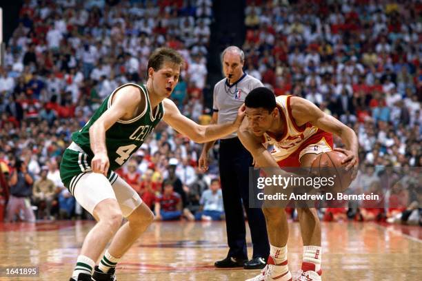 Glenn "Doc" Rivers of the Atlanta Hawks looks to pass during the 1988 NBA game against Danny Ainge of the Boston Celtics at the Omni in Atlanta,...