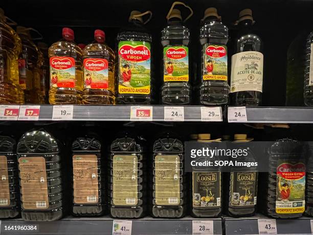 Bottles of olive oil and labels with high prices from a large supermarket chain in Madrid. The price of olive oil in Spain has risen sharply in...