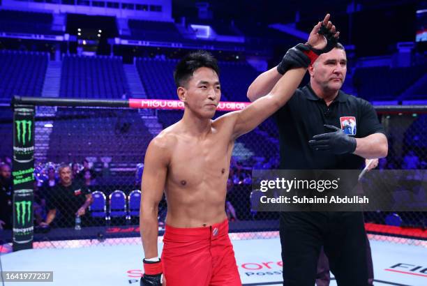 Jiniushiyue of China reacts after his victory against SeungGuk Choi of South Korea in a flyweight fight during the Road to UFC event at Singapore...