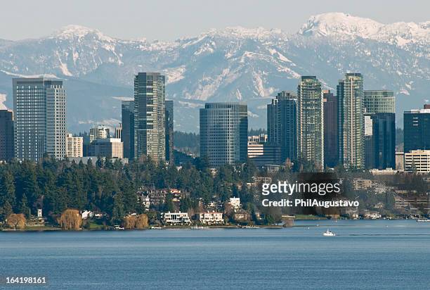 lake washington and city of bellevue with mountain range behind - washington state stock pictures, royalty-free photos & images