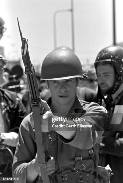 Close-up of a California National Guardsman as he stands, bayonet at the ready, on guard during protests near People's Park on the campus of the...