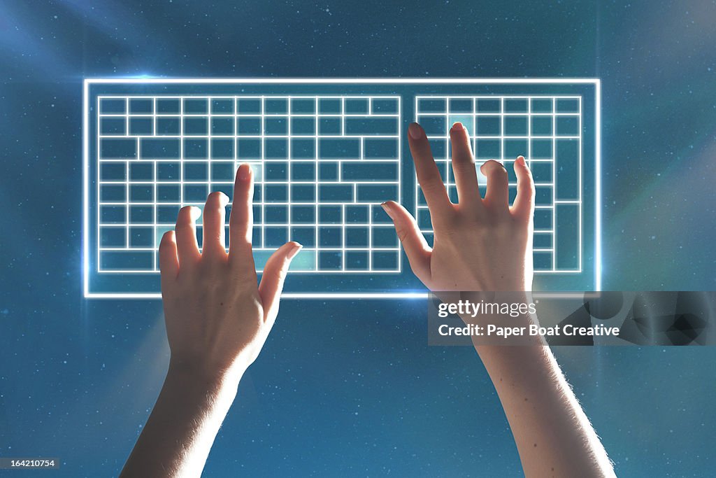Hands typing on virtual keyboard stars background