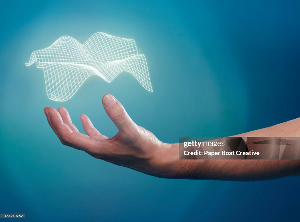 Hand supporting a floating 3D grid over his palm