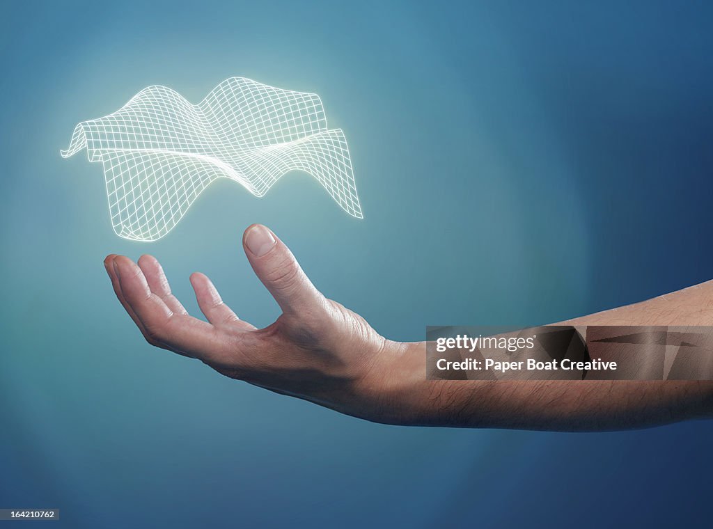 Hand supporting a floating 3D grid over his palm