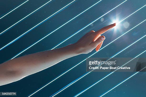 finger touching line of light in starry background - points of light gala stockfoto's en -beelden