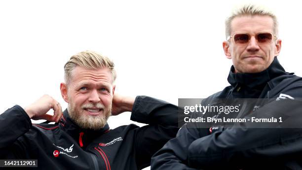 Kevin Magnussen of Denmark and Haas F1 and Nico Hulkenberg of Germany and Haas F1 look on from the drivers parade prior to the F1 Grand Prix of The...