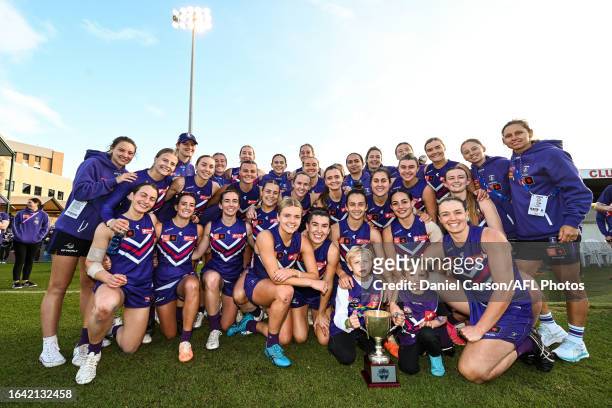 The Dockers pose for a team photo with the RAC Derby Cup during the 2023 AFLW Round 01 match between the Fremantle Dockers and the West Coast Eagles...