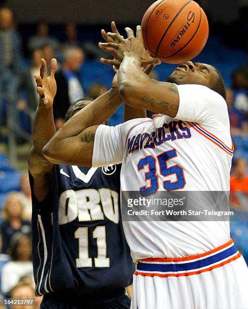 Texas-Arlington's Brandon Edwards has his shot blocked by Oral Roberts' Shawn Glover in the first round of the 2013 CollegeInsider.com tournament on...