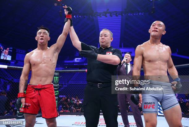 Rongzhu of China reacts after his victory over Sangwook Kim of South Korea in a lightweight fight during the Road to UFC event at Singapore Indoor...