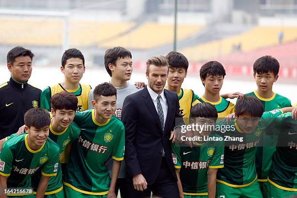 British football player David Beckham poses for a photo with Beijing Guo'an players during his visits Beijing Guo'an Football Club at Workers Stadium...