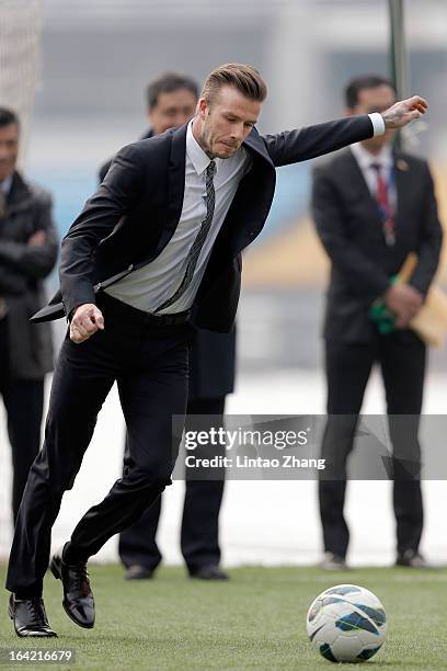 British footballer David Beckham kicks a ball during his visits Beijing Guo'an Football Club at Workers Stadium on March 21, 2013 in Beijing, China....