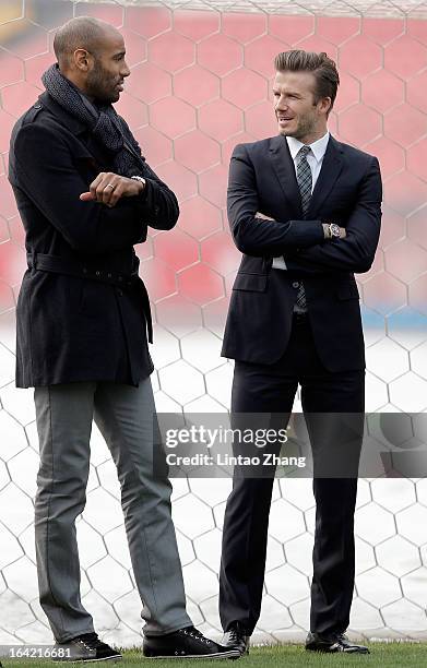 Frederic Kanoute of Beijing Guo'an chats with British football player David Beckham during his visit to Beijing Guo'an Football Club at Workers...