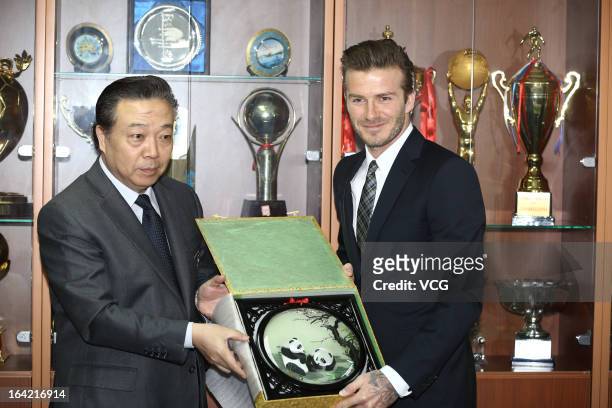 Bejing Guoan General Manager Gao Chao presents a gift to David Beckham at Workers Stadium on March 21, 2013 in Beijing, China.